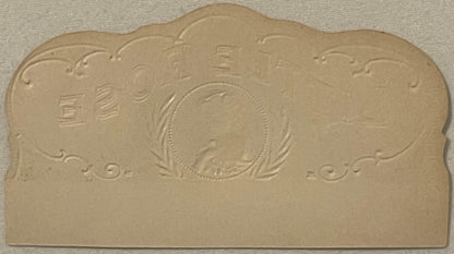 Cream-colored embossed cigar box label with central oval portrait surrounded by decorative flourishes and Asian characters, p