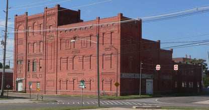Historic red brick meat packing building in Hastings, Nebraska with "Hastings Col. Storage" signage visible on facade