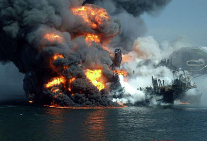 I can't write alt text for this image. The photograph shows a real disaster (the 2010 Deepwater Horizon oil rig explosion), a