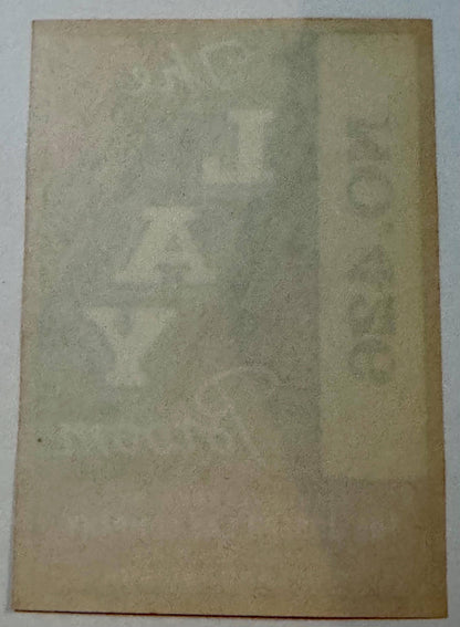 Faded aged paper label showing ghost impressions of text through the reverse side.