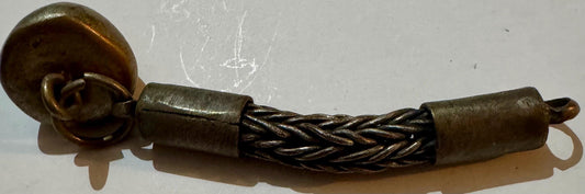Antique brass foxtail chain with dome ornament and cylindrical end caps on white surface.