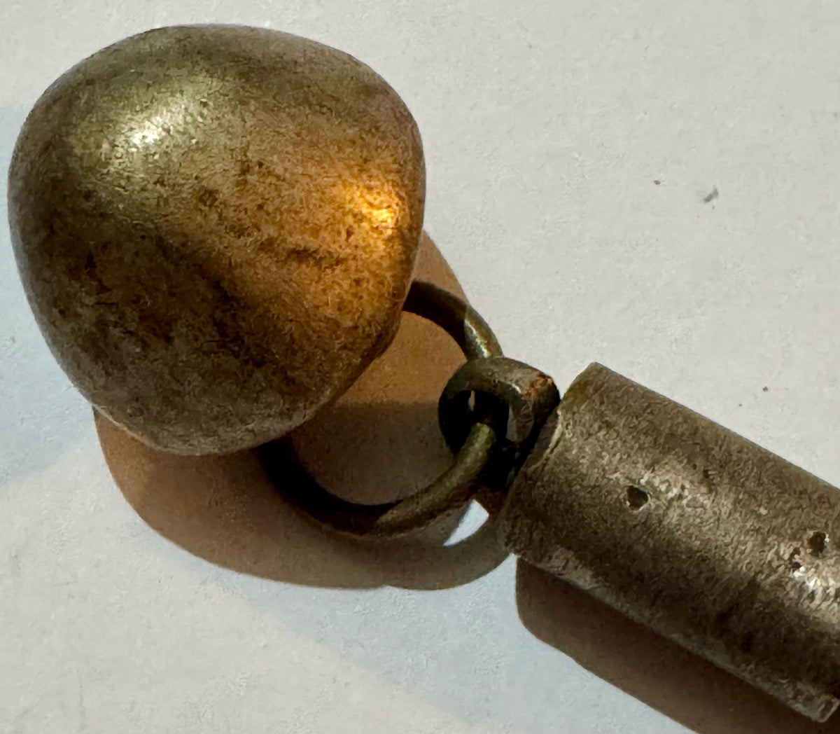 Antique brass dome pendant with foxtail chain link attachment on white surface.