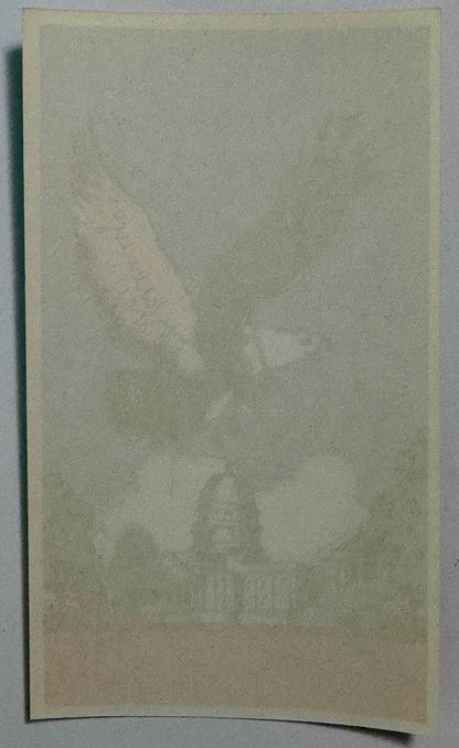 Blank cream-colored vintage broom label with water stains and wear, photographed flat against gray background