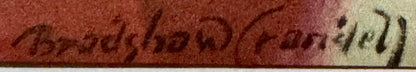 Close-up of vintage lithograph edge showing embossed text on red and cream colored paper with wear visible along the border