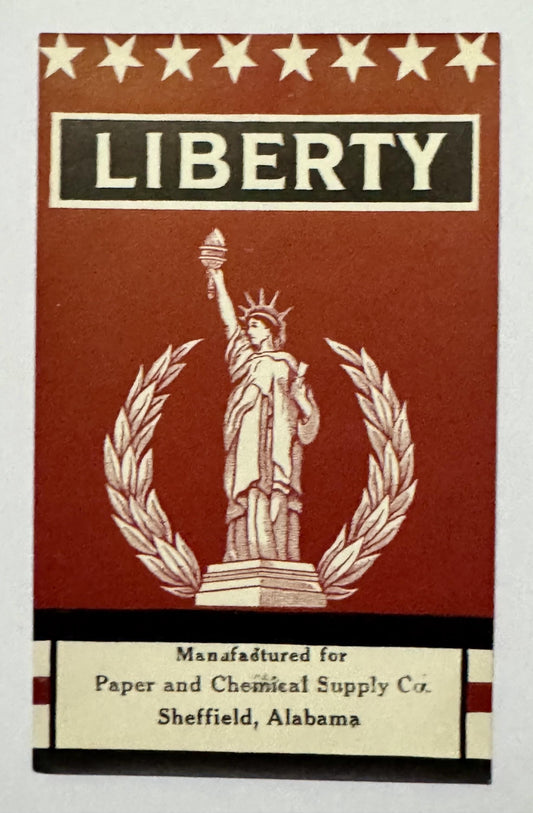 Vintage LIBERTY broom label close-up: the Statue of Liberty in a laurel wreath under eight stars, Paper and Chemical Supply Co. imprint below
