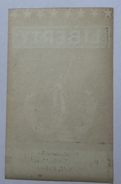 Blank back of the LIBERTY broom label with the star, lettering and imprint lines showing through the paper
