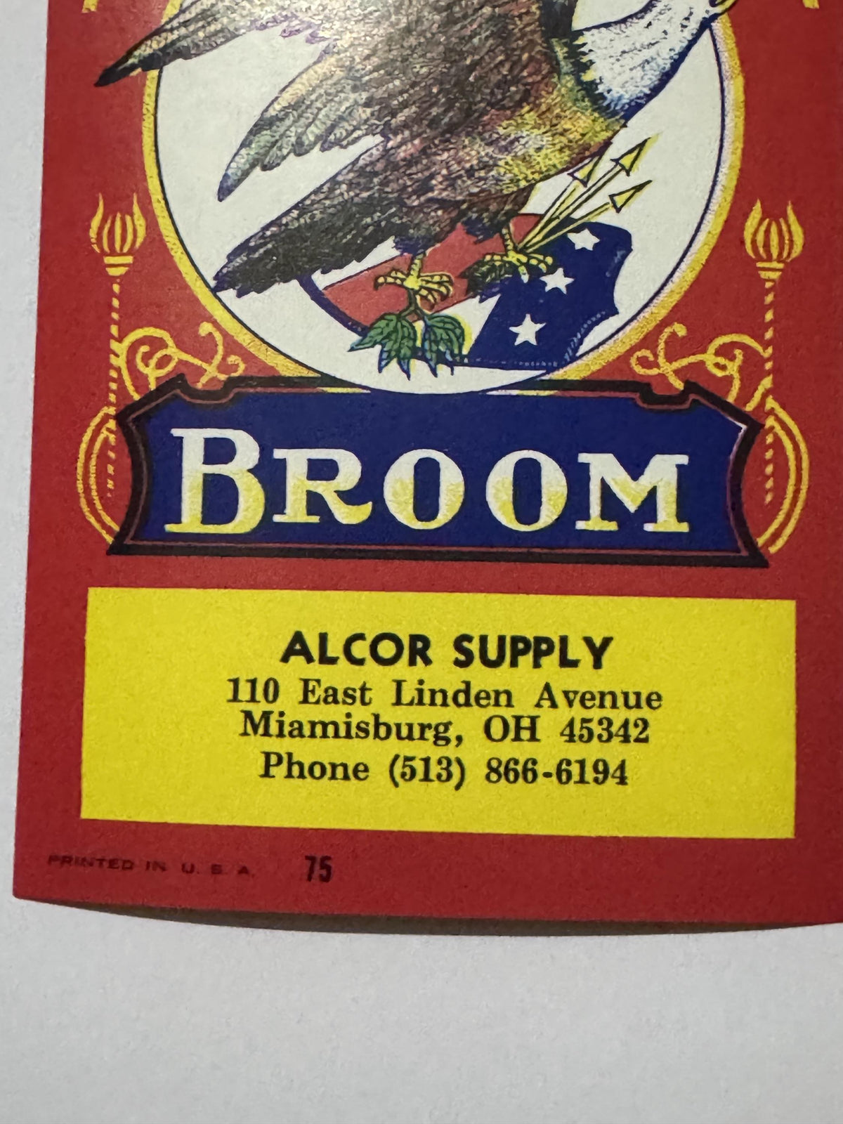Lower half of the label: the BROOM banner, the yellow Alcor Supply imprint panel for Miamisburg, Ohio, and PRINTED IN U.S.A. 75 on the red margin