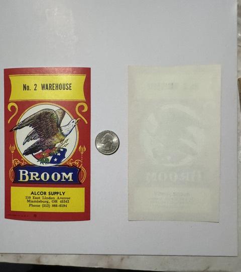 The label front beside its blank back and a US quarter for scale, the print showing faintly through the back
