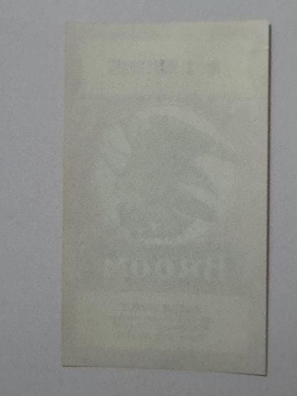 The blank back of the label, the eagle and BROOM showing faintly through the paper