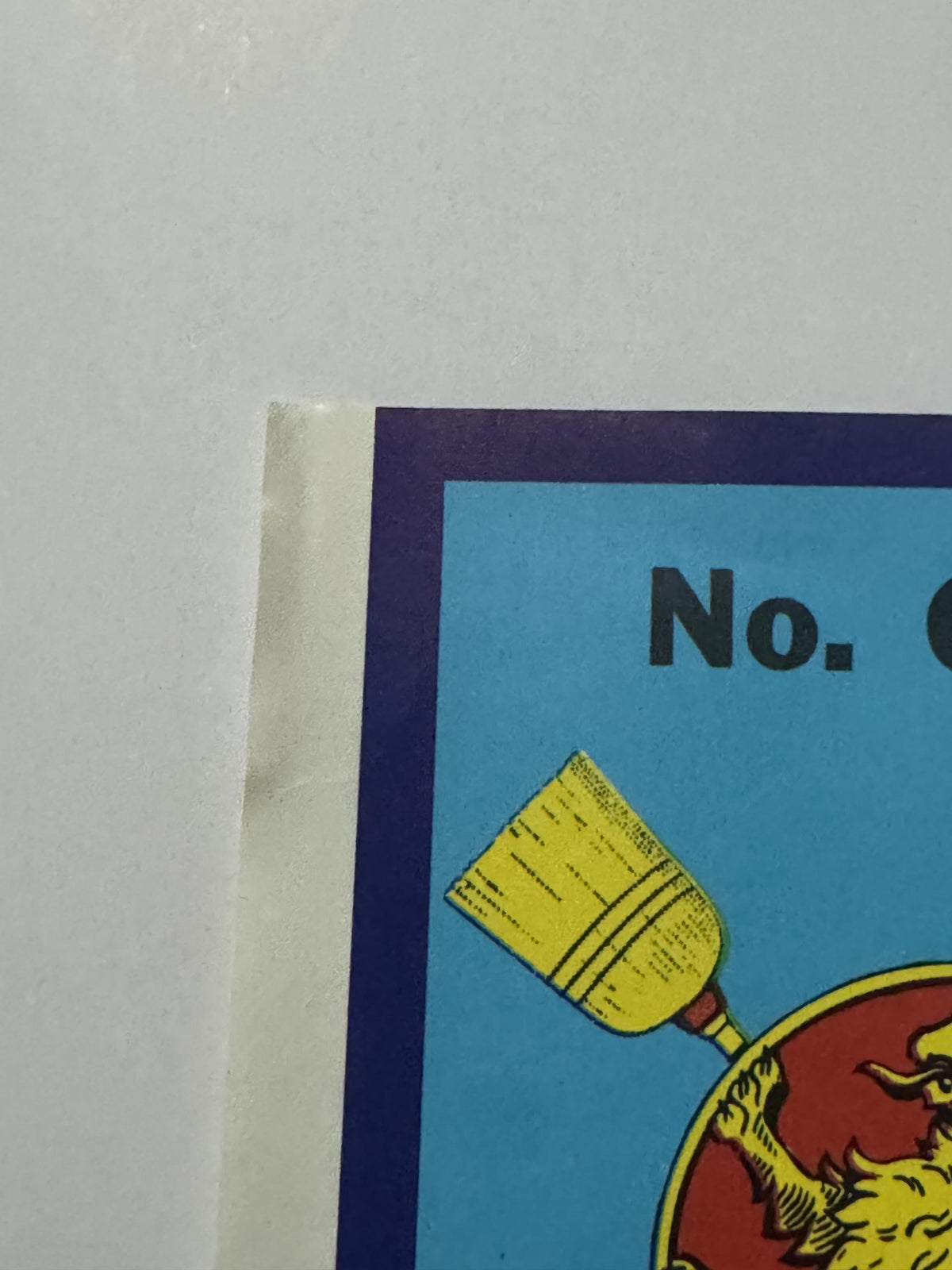 Top left corner of the label, where the light corner wear is