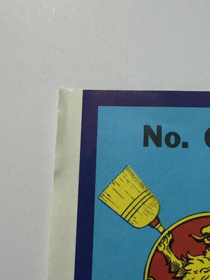 Top left corner of the label, where the light corner wear is