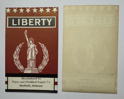 LIBERTY broom label front and its blank back side by side, the front's design showing faintly through the back