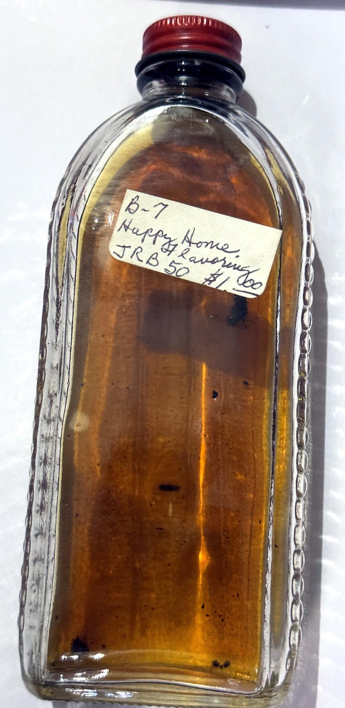 Back view of the Happy Home vanilla bottle and its beaded glass side panels