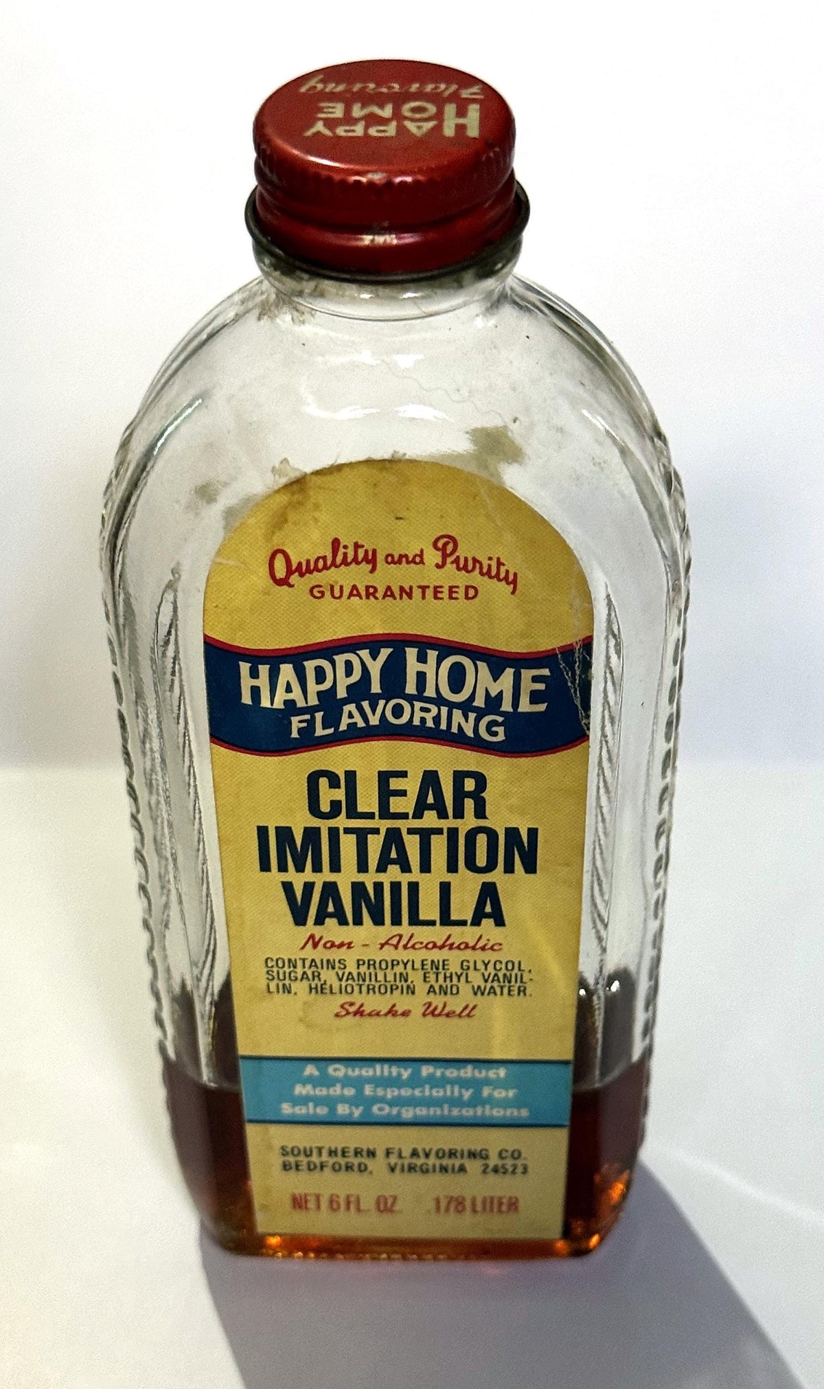 Happy Home Clear Imitation Vanilla bottle standing upright with the label facing front