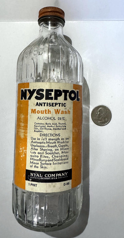 Vintage 1940s Nyseptol Antiseptic Mouth Wash bottle from the Nyal Company of Detroit, a ribbed clear glass pint with its label and NYAL cap