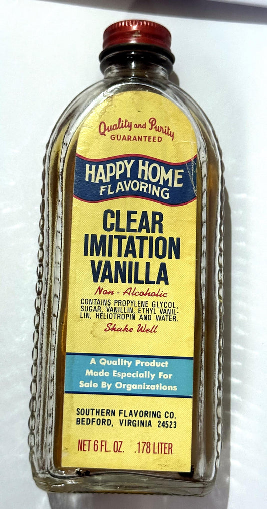Vintage Happy Home Clear Imitation Vanilla bottle from Southern Flavoring Co. of Bedford, Virginia, with its red Happy Home cap