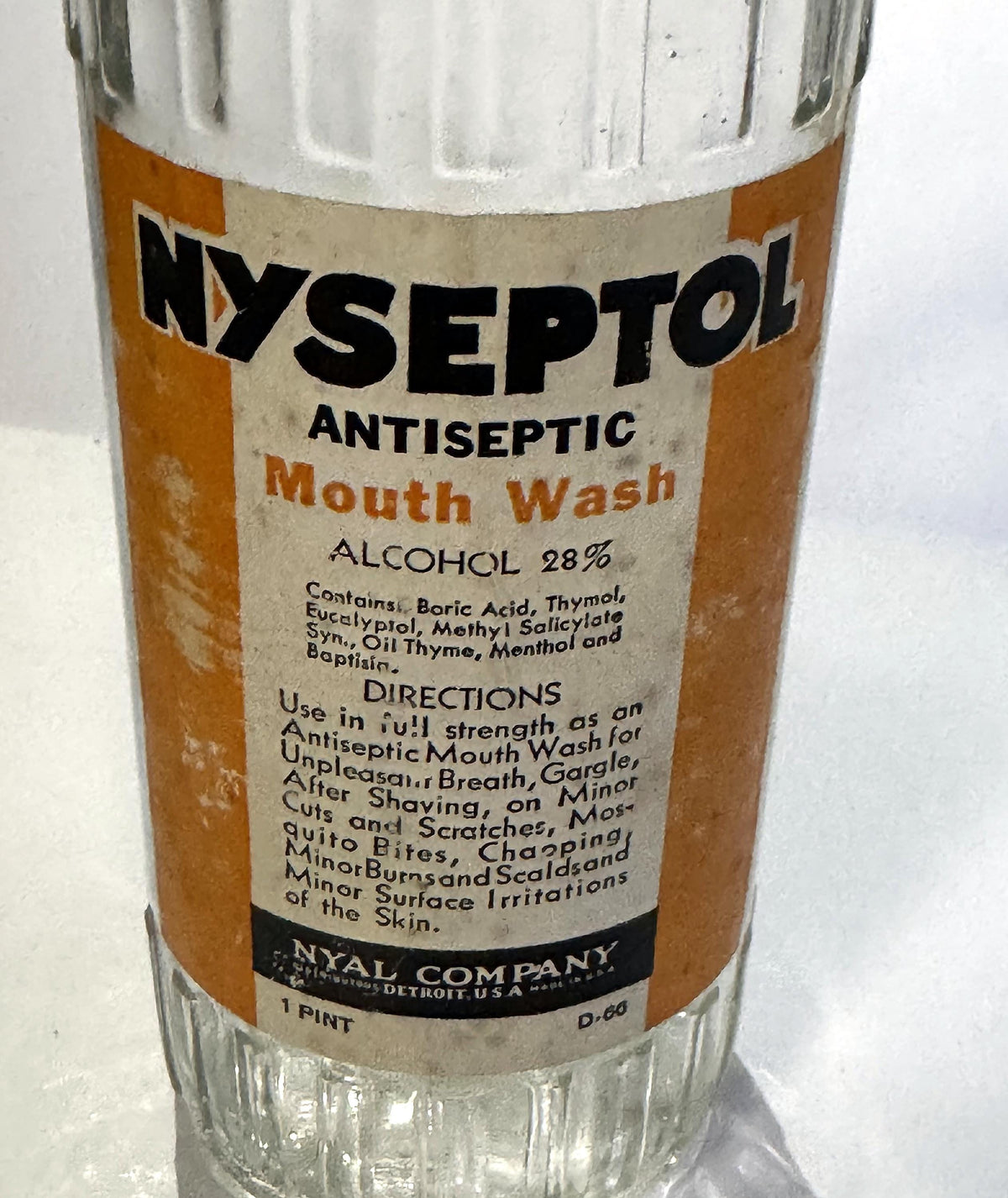 Angled view of the Nyseptol Mouth Wash label with the Nyal Company band, 1 Pint and the code D-66