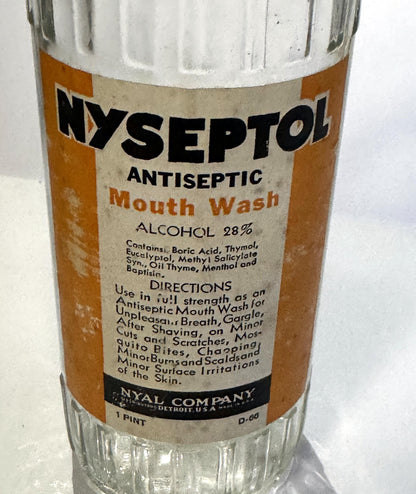 Angled view of the Nyseptol Mouth Wash label with the Nyal Company band, 1 Pint and the code D-66