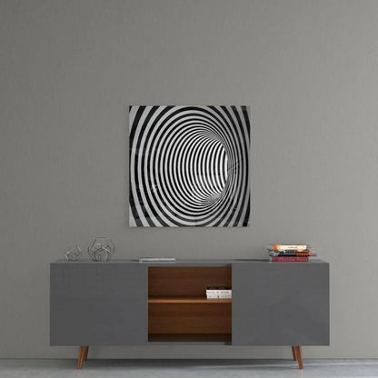 Black and white mesmerizing spiral optical illusion glass wall art on gray wall