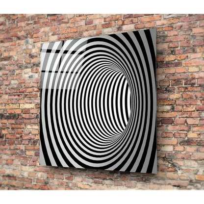 Black and white spiral optical illusion glass wall art panel on brick wall
