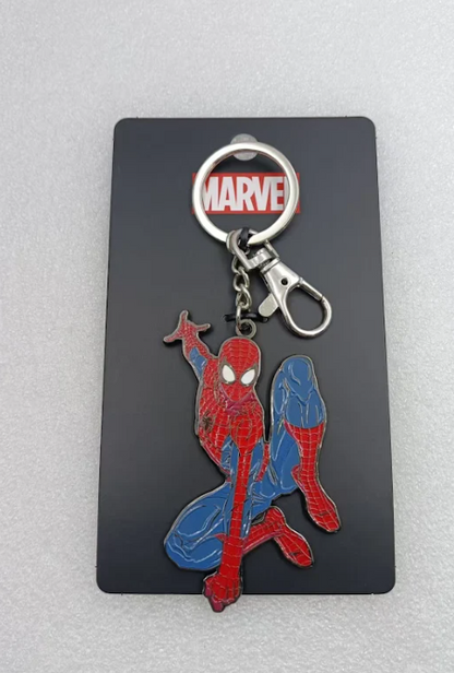Front view of a red and blue enamel Spider-Man keychain on a black card with a red MARVEL logo.