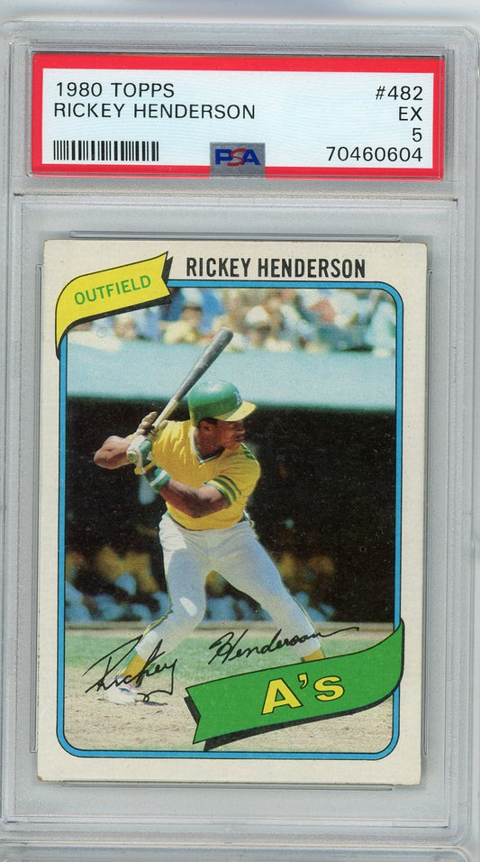 Front of graded 1980 Topps Rickey Henderson baseball card in clear PSA holder, showing player in yellow Athletics uniform batting.
