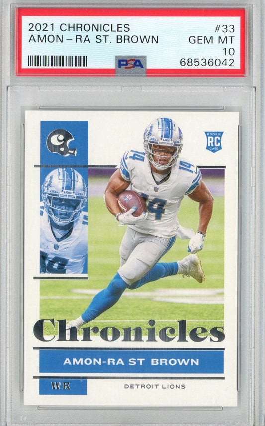 Front of graded PSA 10 card featuring Amon-Ra St. Brown in Detroit Lions uniform running with football, blue and white colors visible.