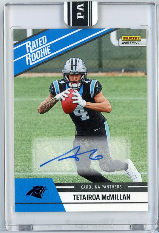 Front of graded football card showing Tetairoa McMillan in Carolina Panthers uniform catching ball, with blue "Rated Rookie" banner and autograph visible.