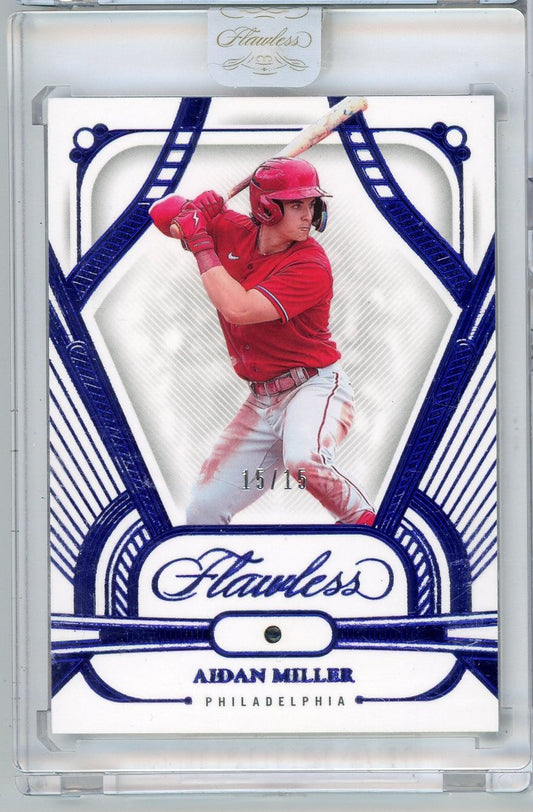 Front of graded baseball card featuring Aidan Miller in red Philadelphia uniform, batting stance, within blue-bordered Flawless design frame, numbered 15/15.