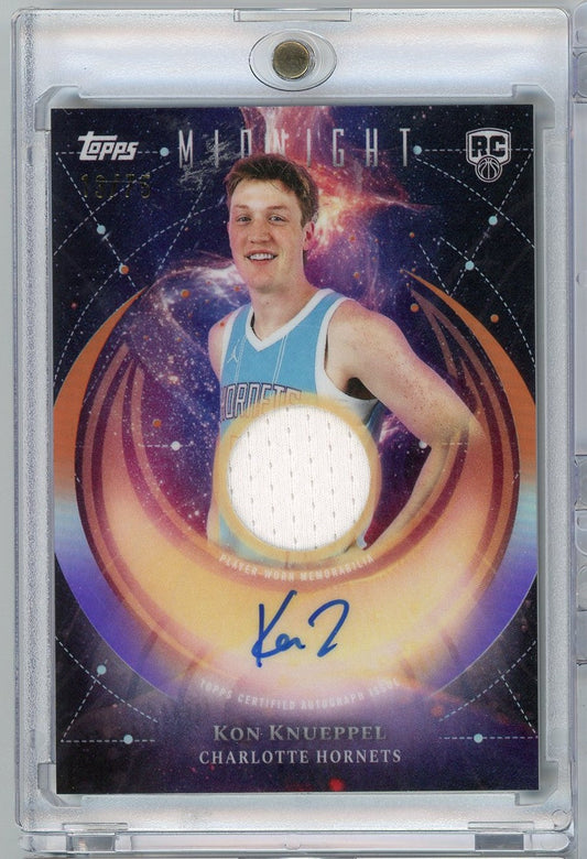 Front of basketball card showing Kon Knueppel in light blue Charlotte Hornets jersey with signed autograph and embedded white jersey swatch against cosmic purple background.