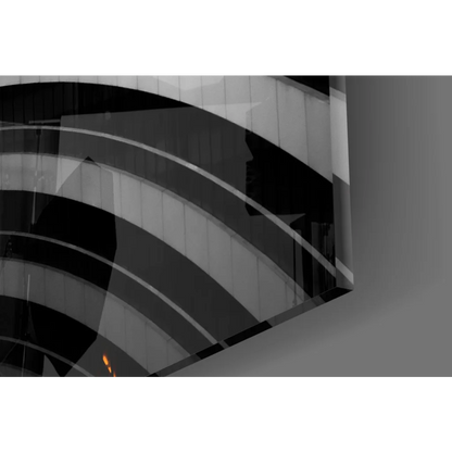 Sleek curved glass wall art with black white stripes and orange glow