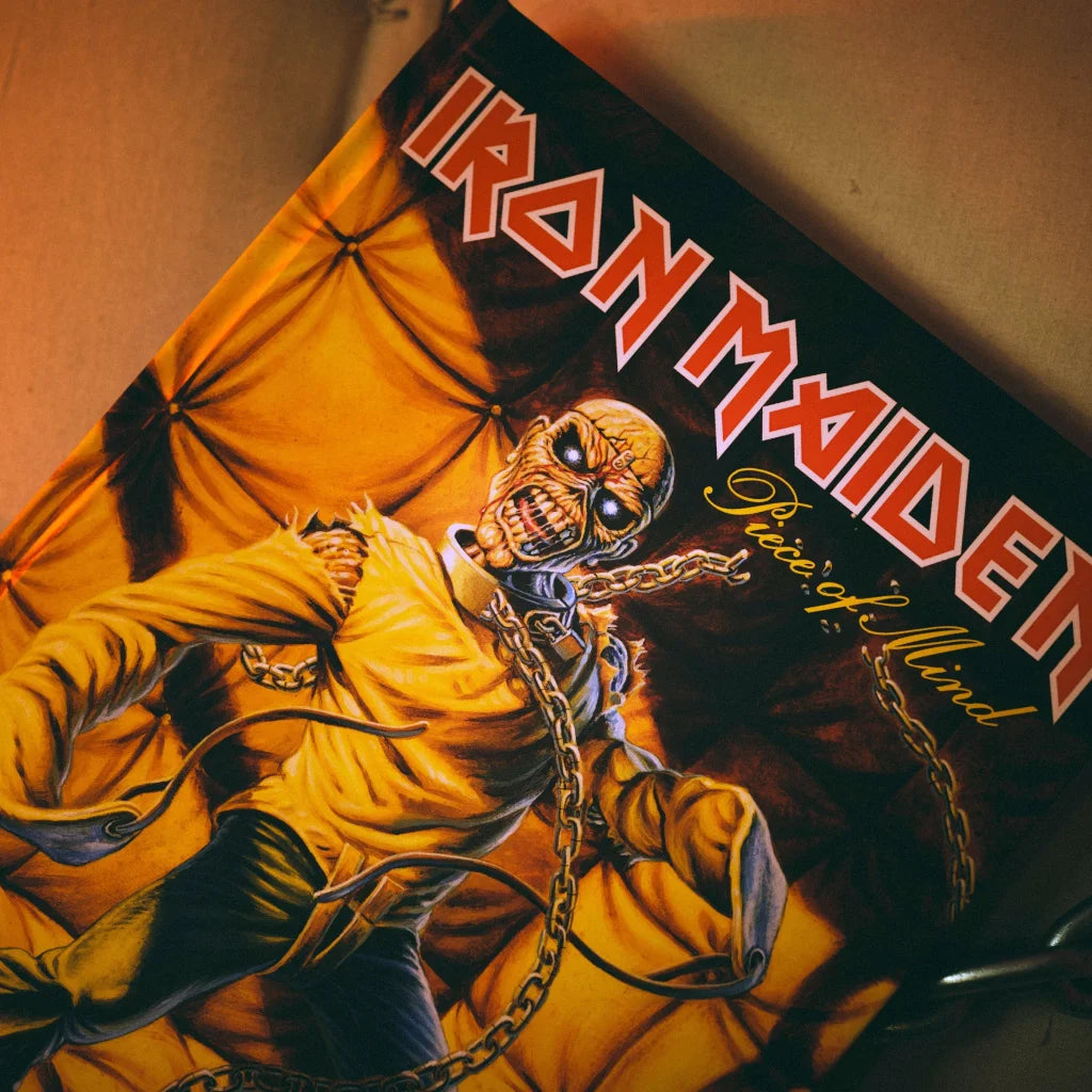 Iron Maiden Piece of Mind Deluxe album cover with chained skeletal figure by Rantz Hoseley