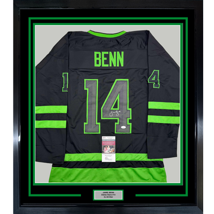 Black and neon green Dallas Stars hockey jersey number 14 signed by Jamie Benn, displayed framed against white backing with JSA authentication certificate visible.