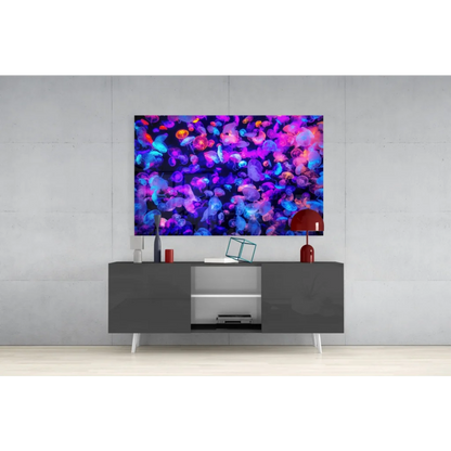Glowing bioluminescent jellyfish glass wall art in purple, blue, pink