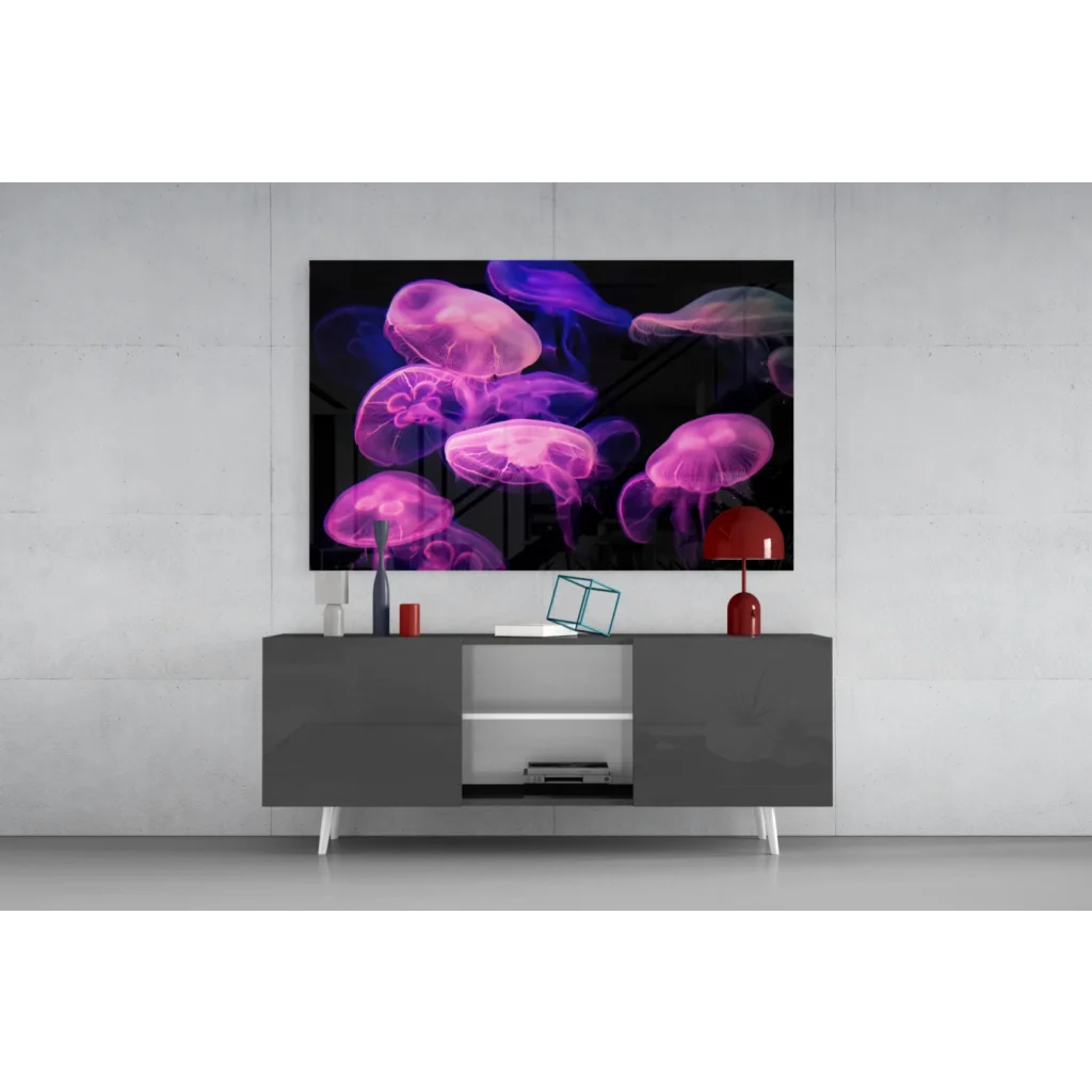 Vibrant pink and purple glowing jellyfish glass wall art on black wall