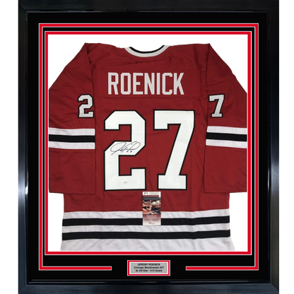 Framed red Chicago Blackhawks hockey jersey number 27 with "ROENICK" nameplate and autographed signature, displayed flat against white matting with black border frame.