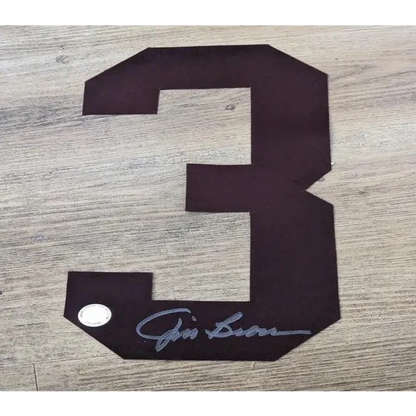 Dark brown Jim Brown autographed number 3 jersey patch with autograph and certificate