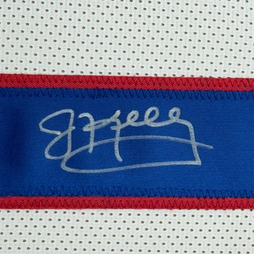 White athletic fabric with blue and red stripes and Jim Kelly signature on Bills jersey