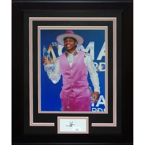 A jimmie allen autographed cma signature series frame featuring a vibrant pink satin vest and pants ensemble