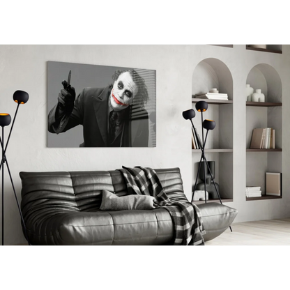 Joker wall art with knife and red lips above black leather sofa