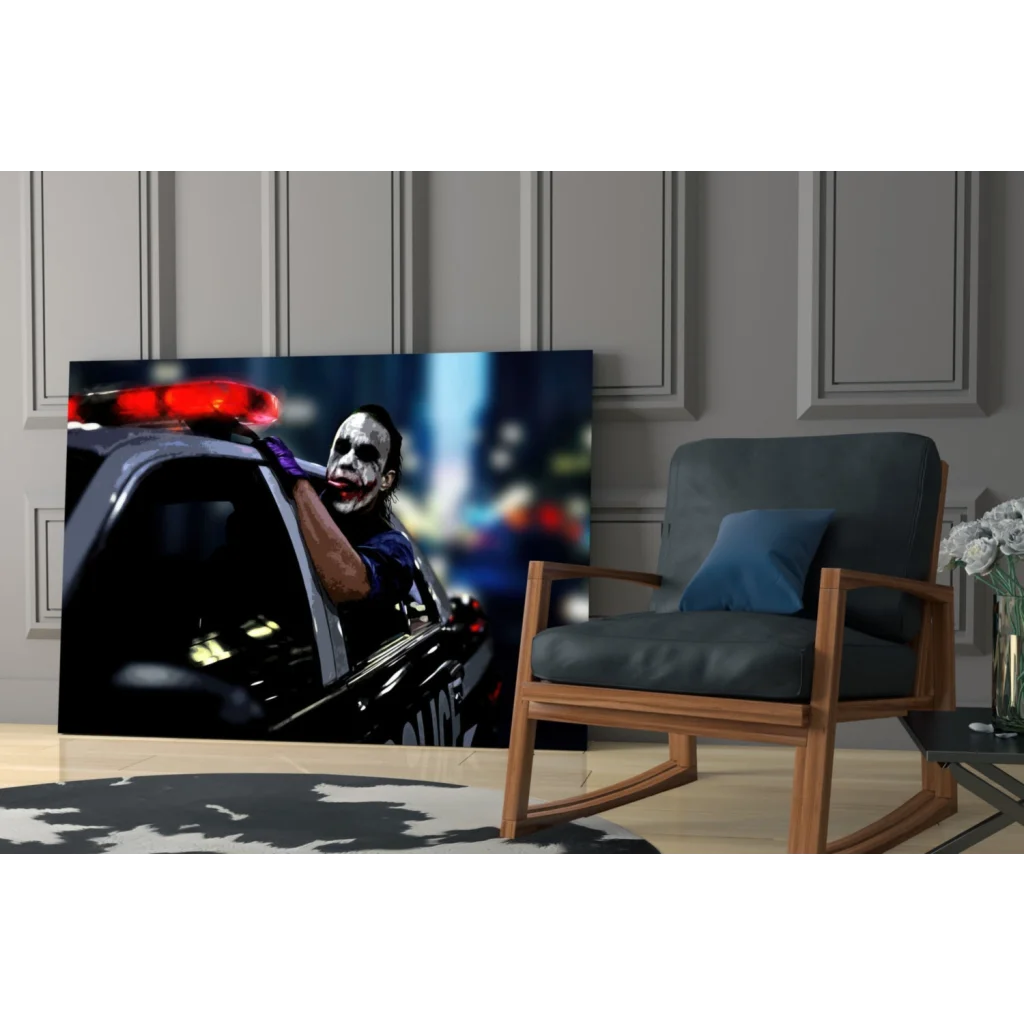 Black and red Joker glass wall art print leaning from police car with flashing lights