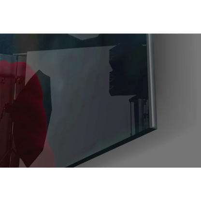 Sleek silver-framed glass wall art reflecting dimly lit room in red tones