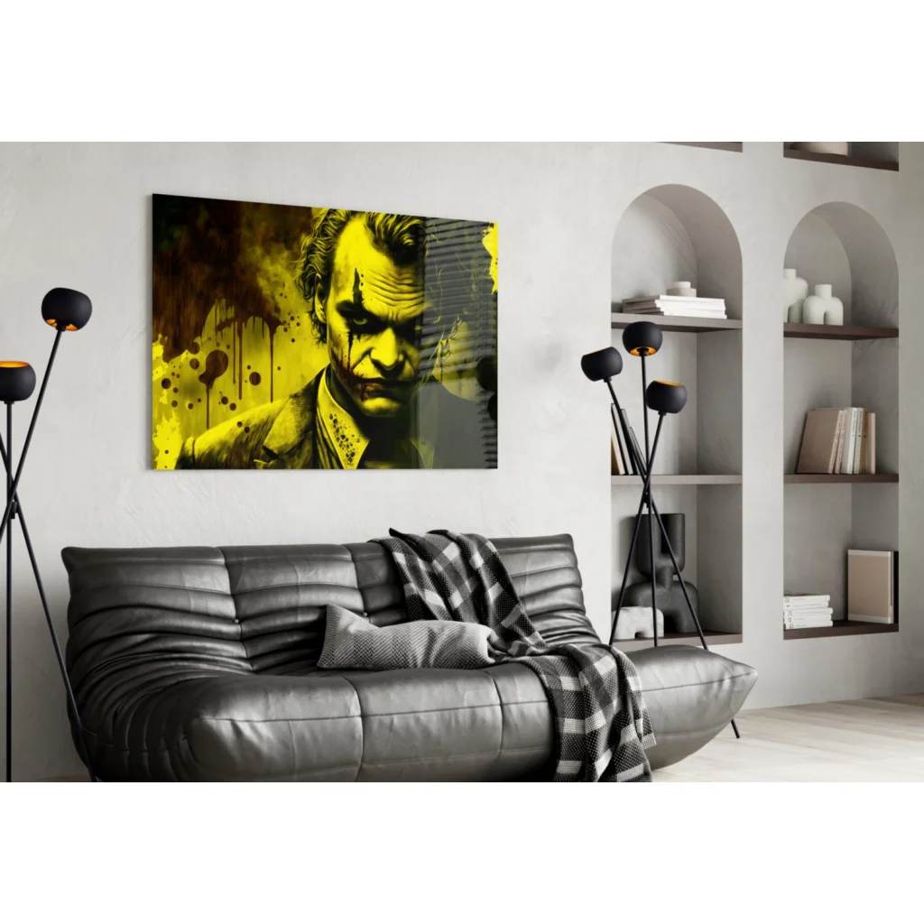 Joker splatter wall art with Joaquin Phoenix over black leather couch and plaid throw