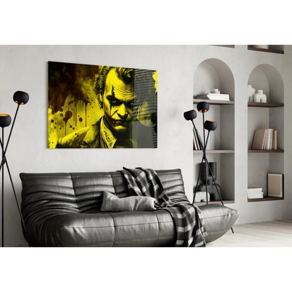 Joker splatter wall art with Joaquin Phoenix over black leather couch and plaid throw