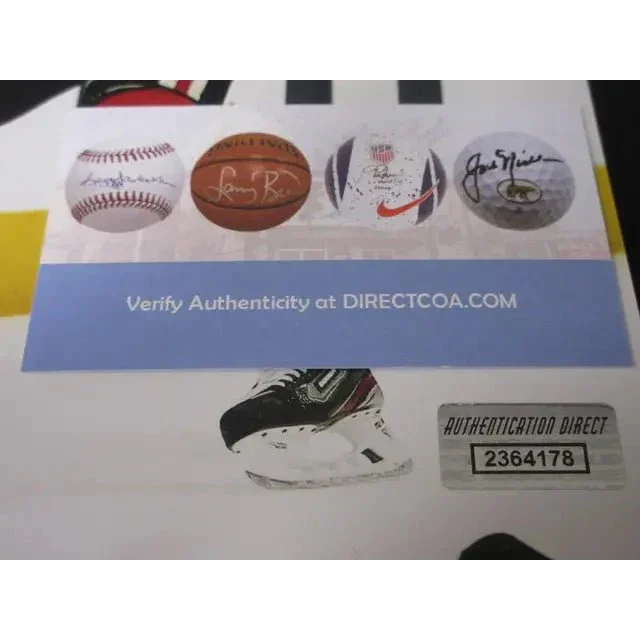 White sheet with autographed sports memorabilia images and authenticity sticker for Jonathan Toews signed 8x10 photo