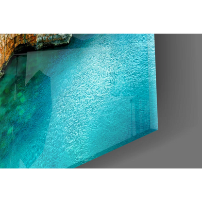 Sleek glass wall art of turquoise waters and rocky cliffs reflection