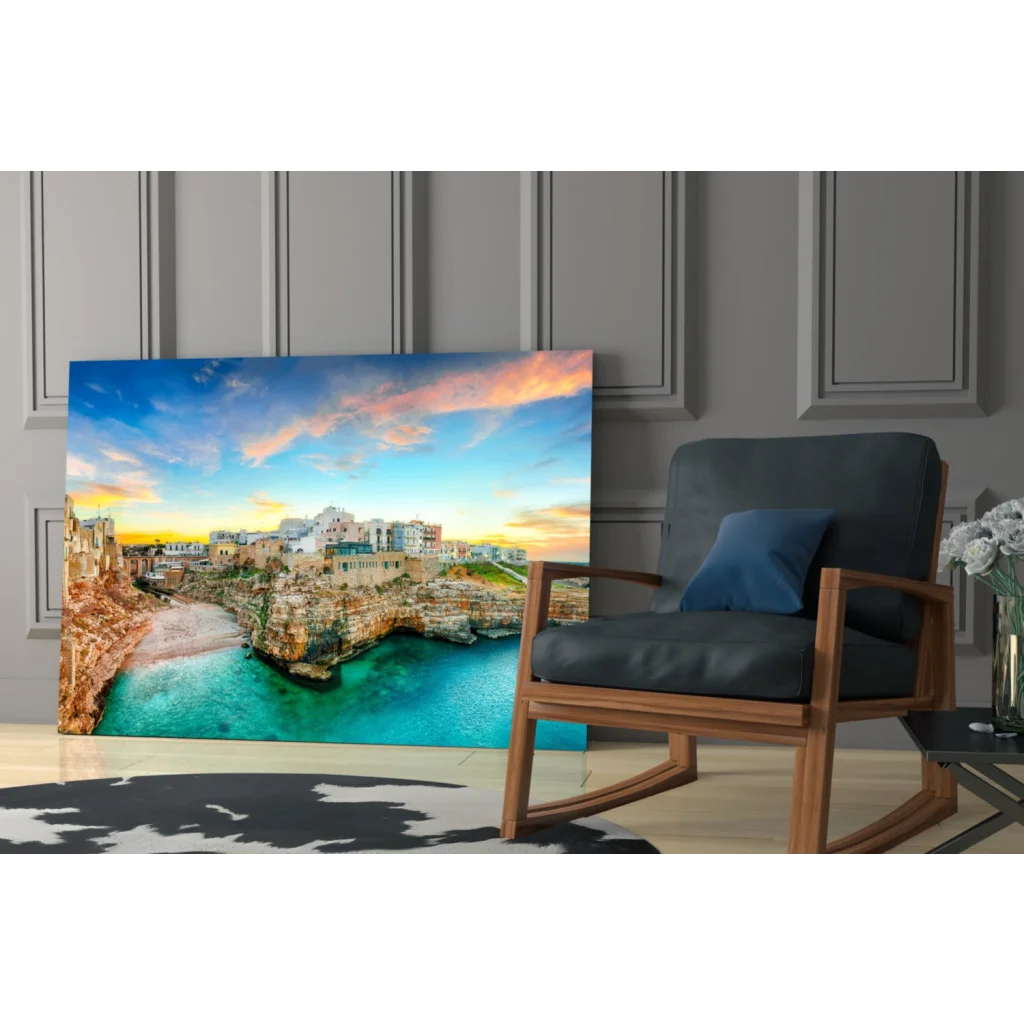 Vibrant coastal town glass wall art with turquoise waters and golden cliffs