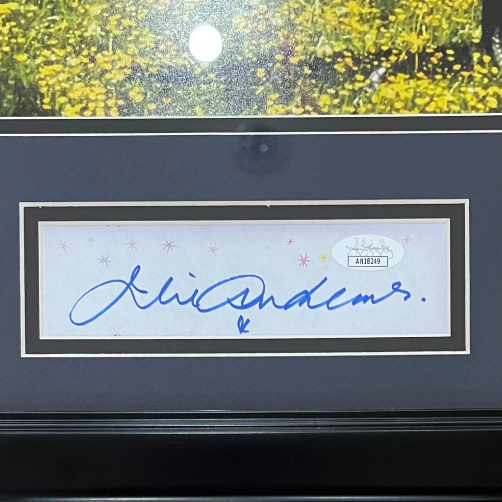 A julie andrews autographed 11x14 photo in a white framed decorative border with blue ink signature and jsa sticker