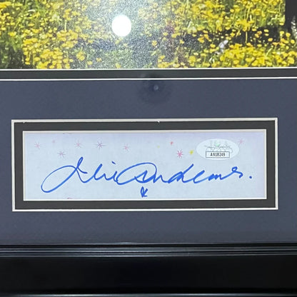 A julie andrews autographed 11x14 photo in a white framed decorative border with blue ink signature and jsa sticker