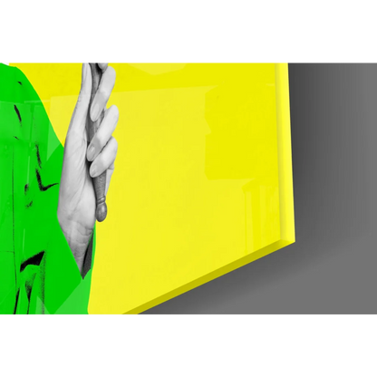Vibrant yellow neon justice glass wall art held by green hand